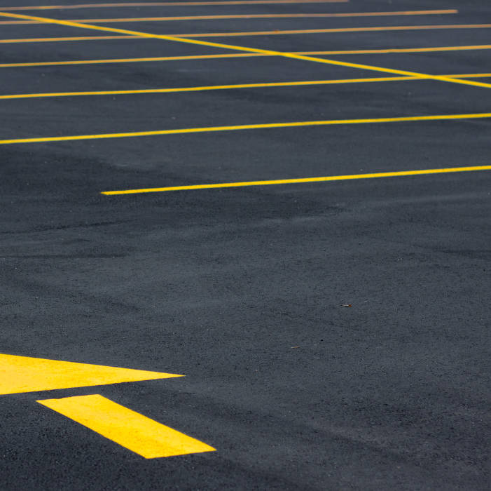 Image of a asphalt parking lot with new stripes