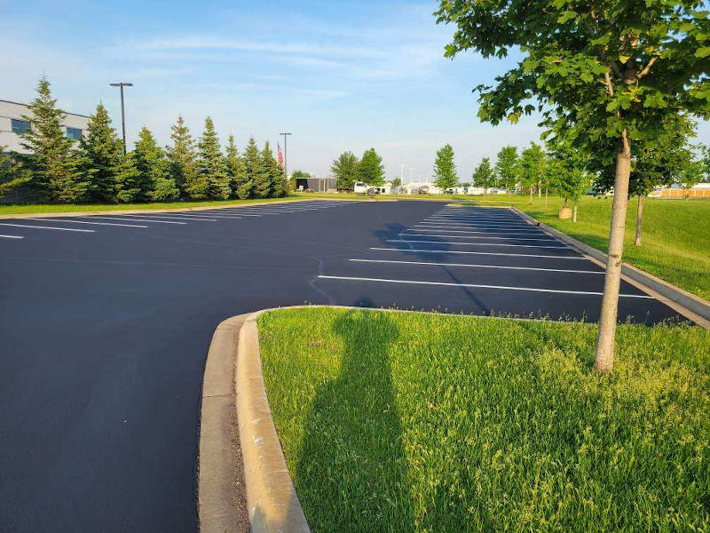 long parking lot that has been sealed and striped