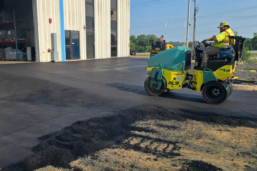 Rolling fresh asphalt for compaction. 