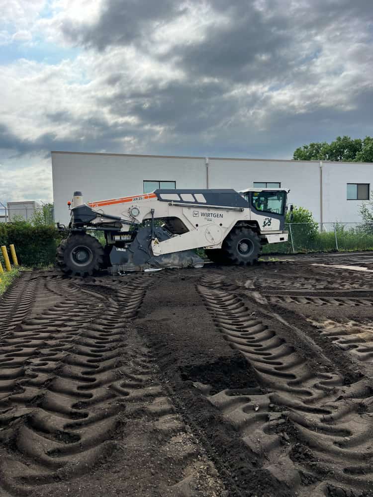 Asphalt reclaiming unit working on parking lot