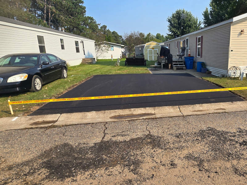 Driveways being paved in mobile home park. 
