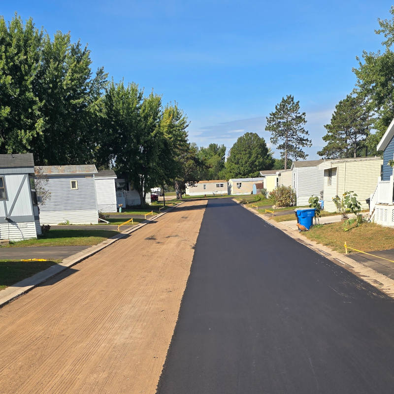 One side of road repaved with asphalt