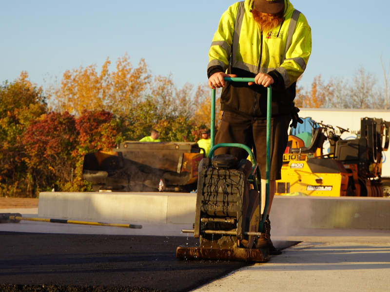 Plate compactor being used for finishing work.