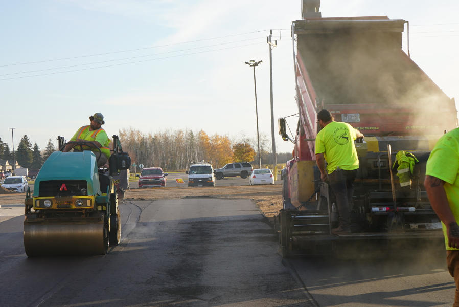 Hot asphalt being installed at Milaca Meats