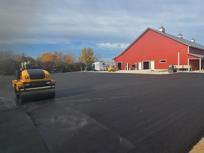 Roller compacting asphalt in new install.