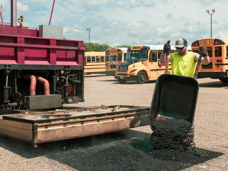Asphalt being added to repair spot