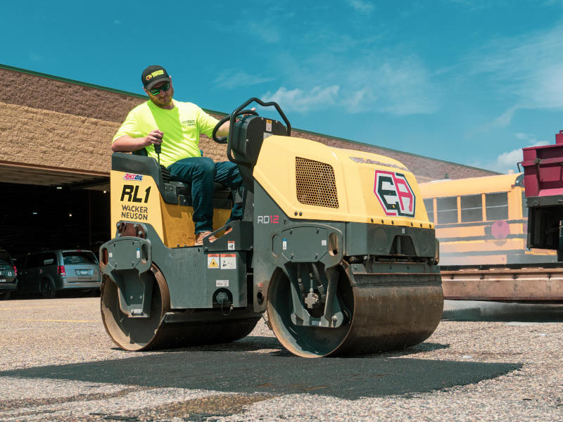 Roller compacting an asphalt repair