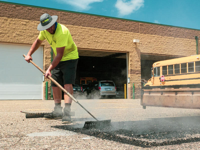 Worker picture framing an IR asphalt repair